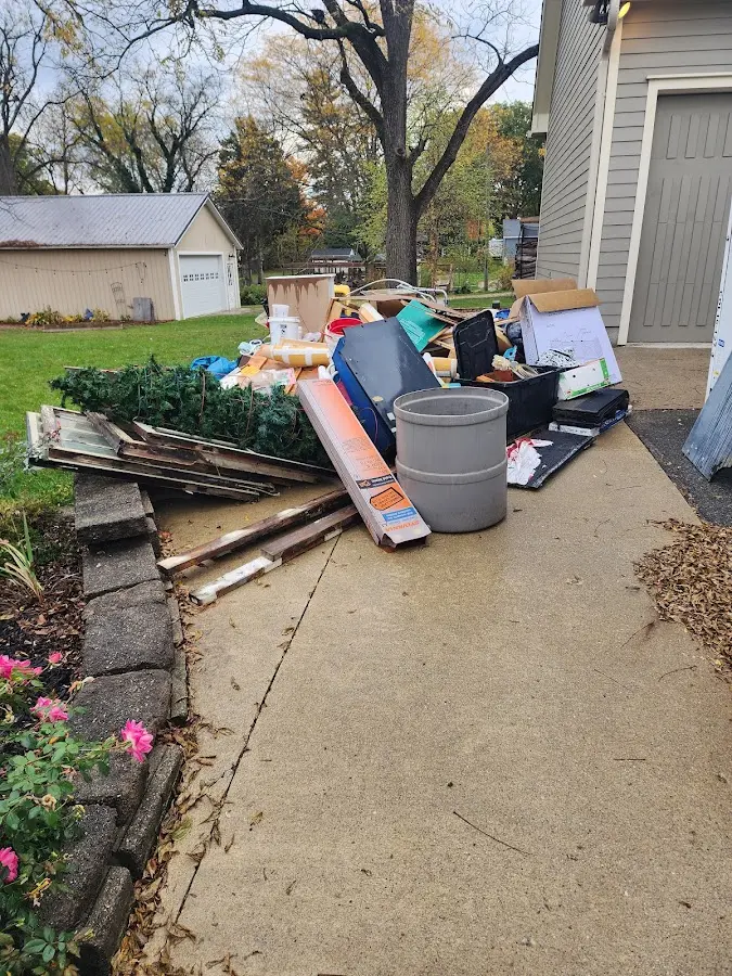 Dumpster being loaded with debris for 3 Yard Dumpster Rental in Tilden